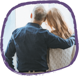 Parents hugging and looking into the distance