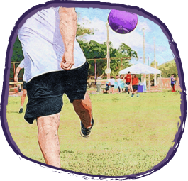 Man kicking a purple football